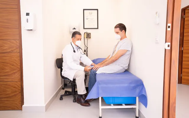 Doctor checking patient's vitals in a clinical setting for health consultation.